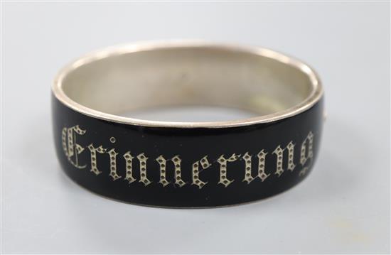 A 19th century German white metal and black enamel mourning hinged bangle, Erinerrung(Memory)